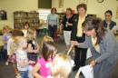 Rotarian Kendra Caskey passes out toothbrushes to the students