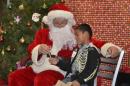 Santa Claus giving gifts at holiday party