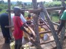 Kisowera school children collecting from the rehabbed borehole